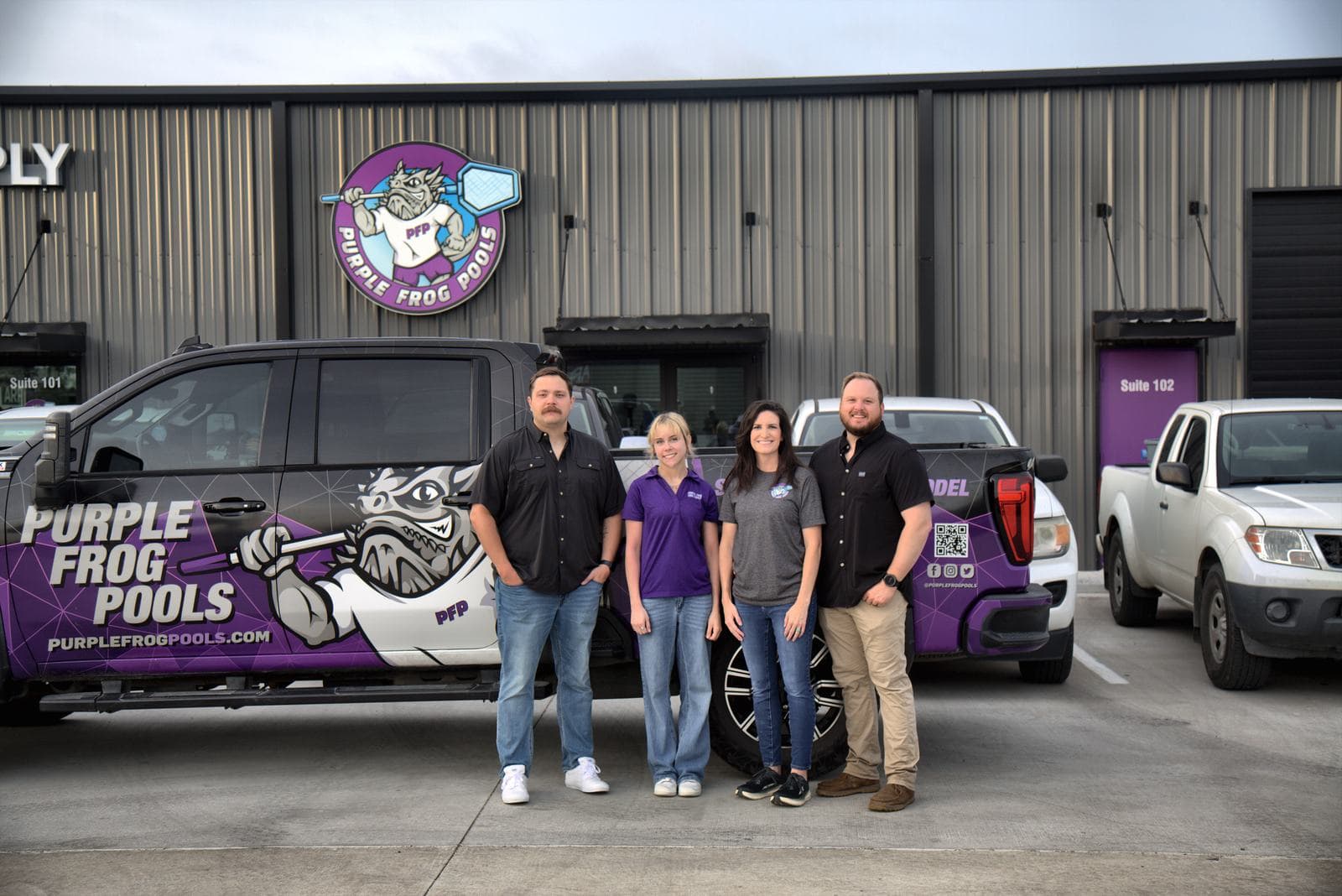 The Purple Frog Pools family team standing with a branded company truck outside their Aledo, TX shop