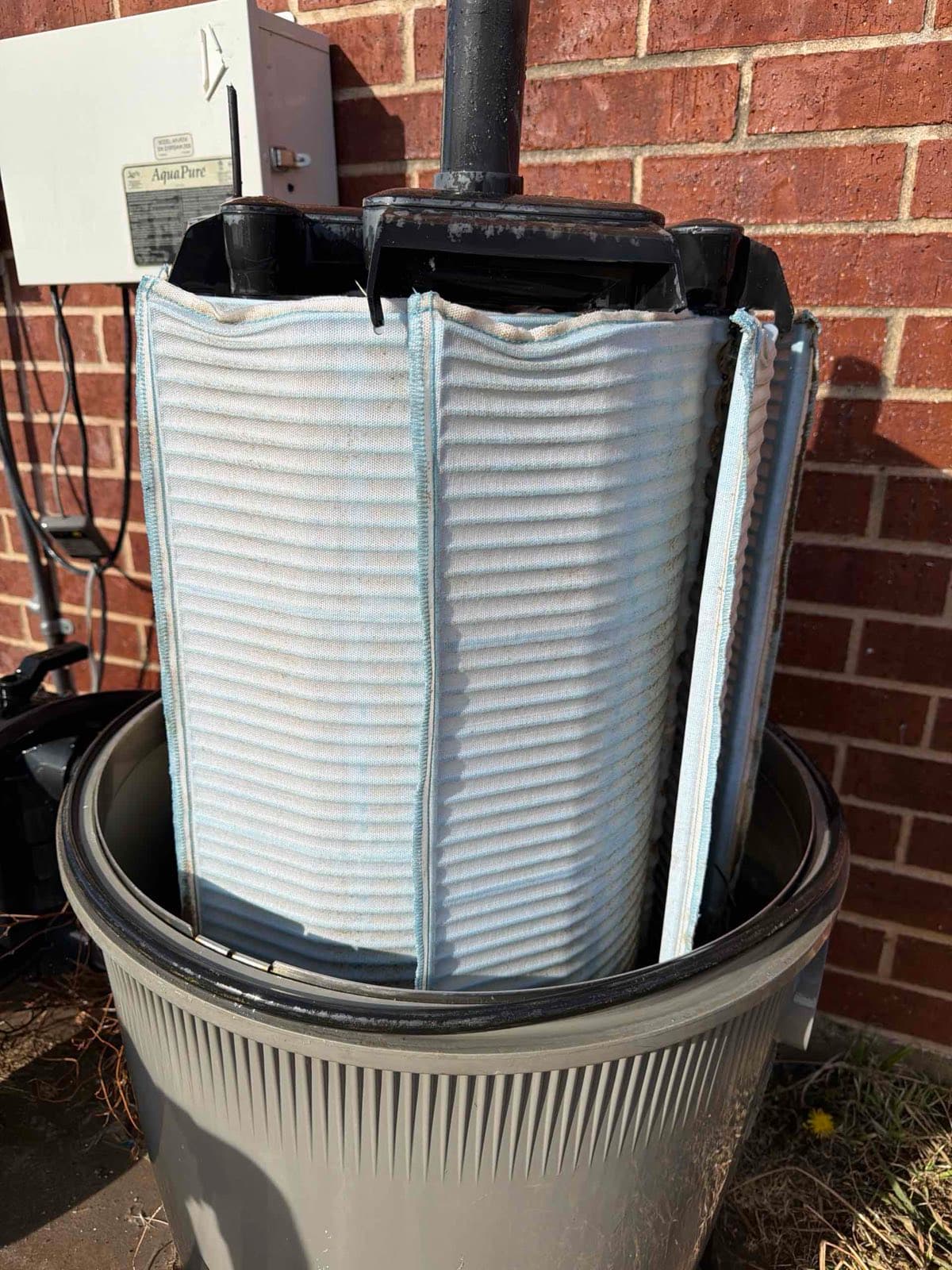 The same pool DE filter grid clean and white after a Purple Frog Pools deep filter clean