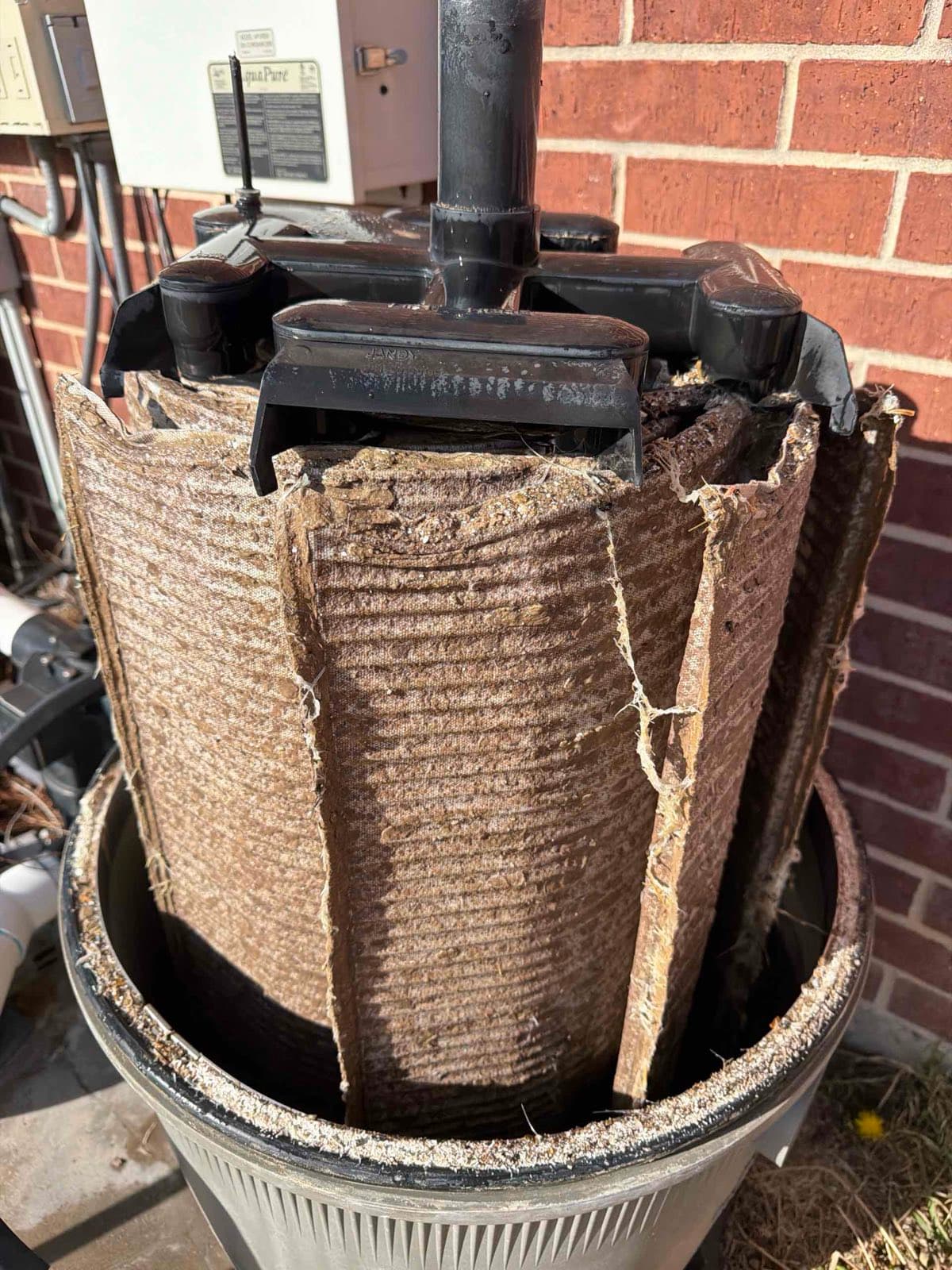 A pool DE filter grid caked with dirt and debris before a Purple Frog Pools deep filter clean